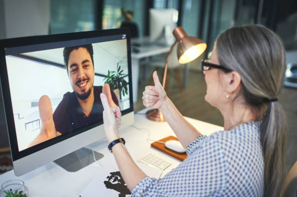 Shot of a young man showing thumbs up during an online counselling session with a psychologist - Online Therapy Counseling Services