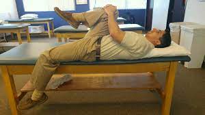 A man doing Supine Psoas Stretch