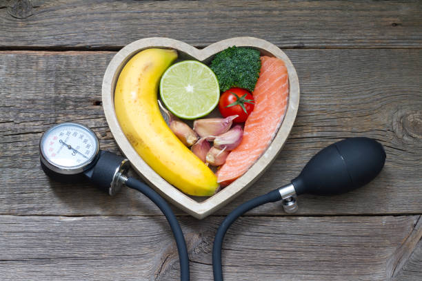 Natural Remedies For High Blood Pressure - Health heart diet food concept with blood pressure gauge closeup