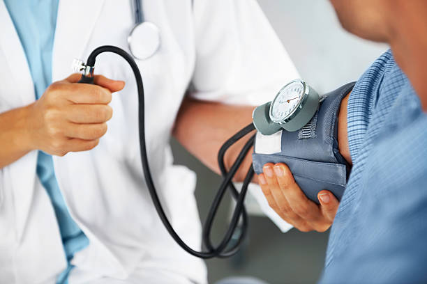 Natural Remedies For High Blood Pressure - A doctor listening to his patient's heartbeat with a stethoscope