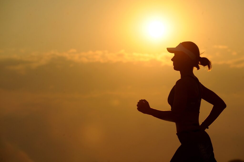 Mental Health - A woman jogging under sunset