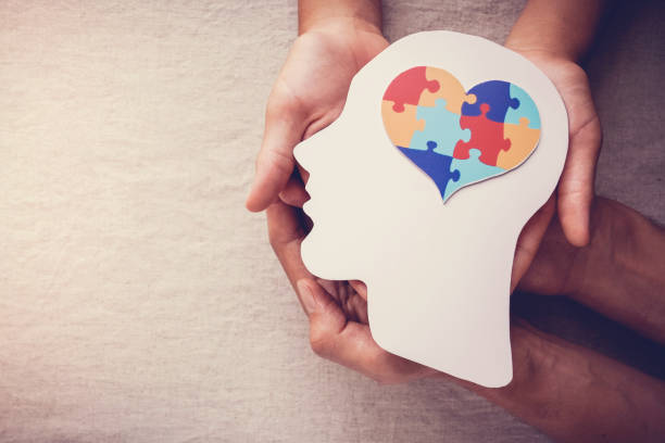 Mental Health - puzzle jigsaw heart on brain, mental health concept, world autism awareness day