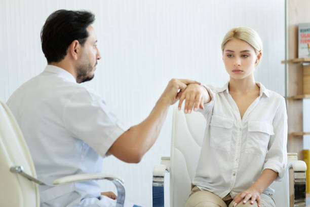 Holding hand of woman during hypnotherapy