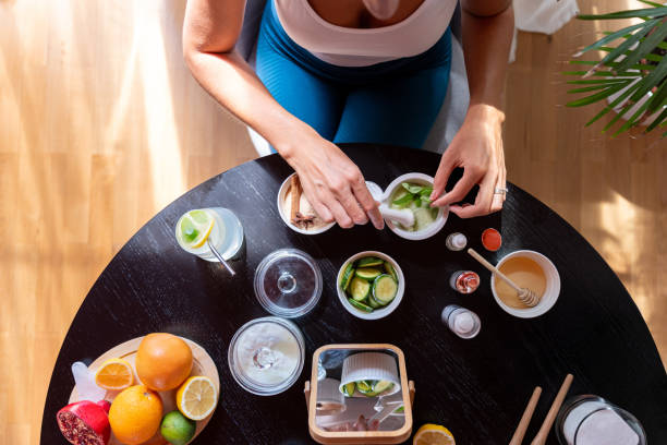 A young woman carefully combines ingredients, prepares a natural mask for skin care.