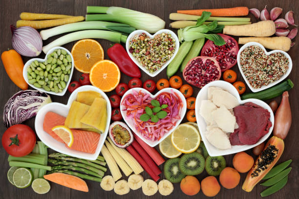 Ornish Diet - Health food for weight loss concept with fish, meat, salads, fresh fruit and vegetables, herbs and herbal medicine used to help weight loss. Top view.